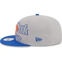 szara-i-niebieska-czapka-z-daszkiem-snapback-9fifty-draft-edition-2023-new-york-knicks-nba-new-era