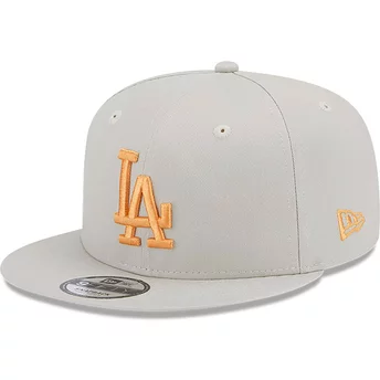 Beżowa, płaska czapka snapback z pomarańczowym logo 9FIFTY Side Patch Los Angeles Dodgers MLB od New Era